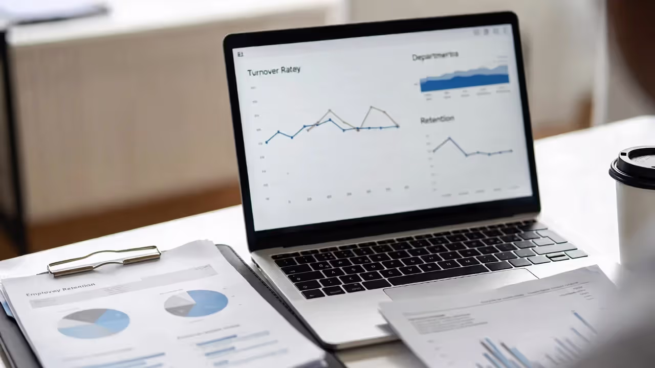 HR manager analyzing employee turnover and retention trends on a laptop