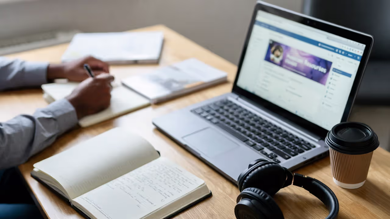 Adult student taking an online human resources course at a home workspace