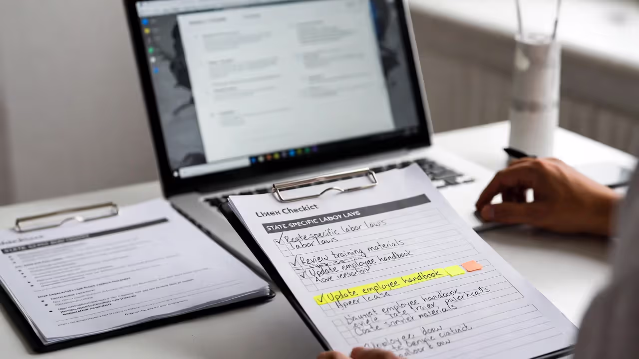 HR specialist reviewing compliance training materials and state law requirements