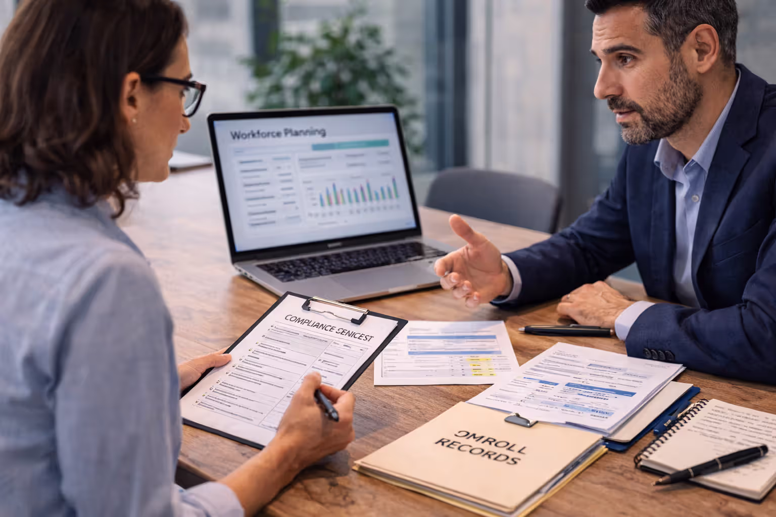 HR business partner and manager discussing workforce planning and compliance strategy