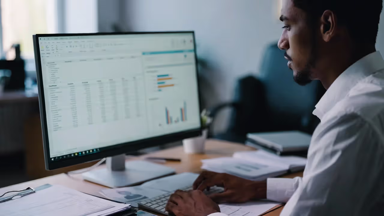 HR analyst preparing workforce compliance reports on a computer