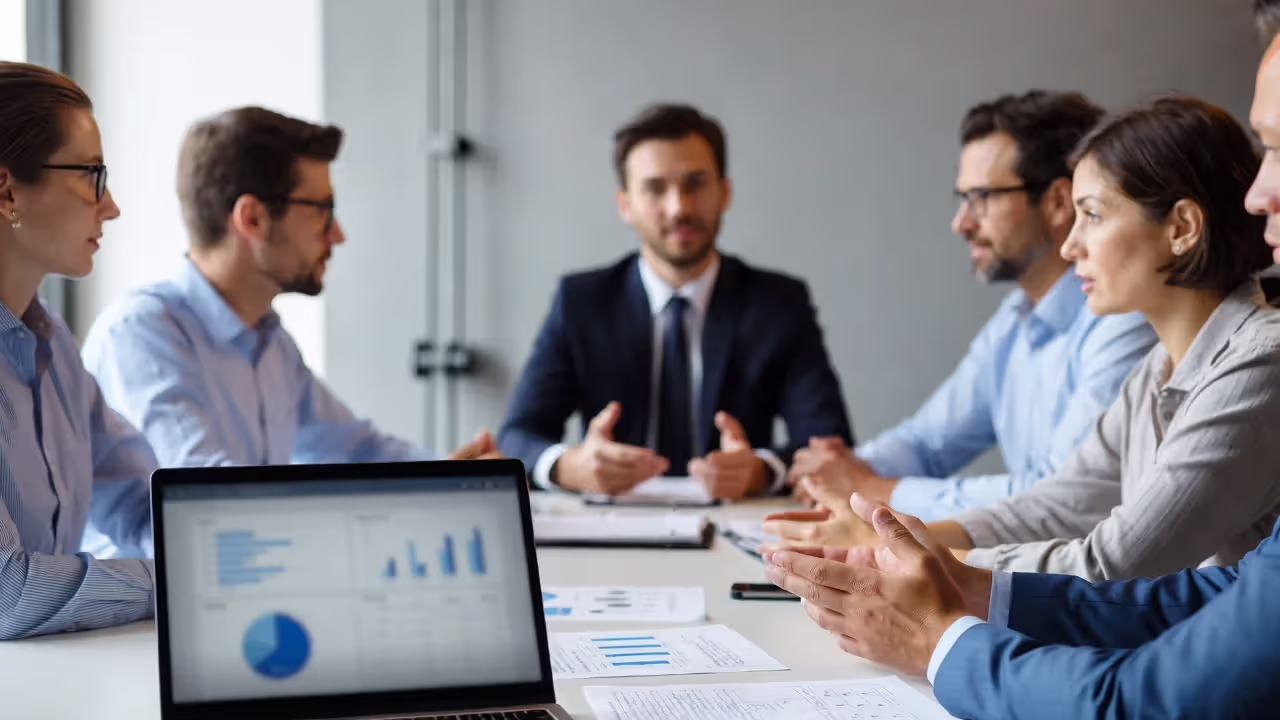 HR leadership team reviewing compliance metrics and reporting schedules